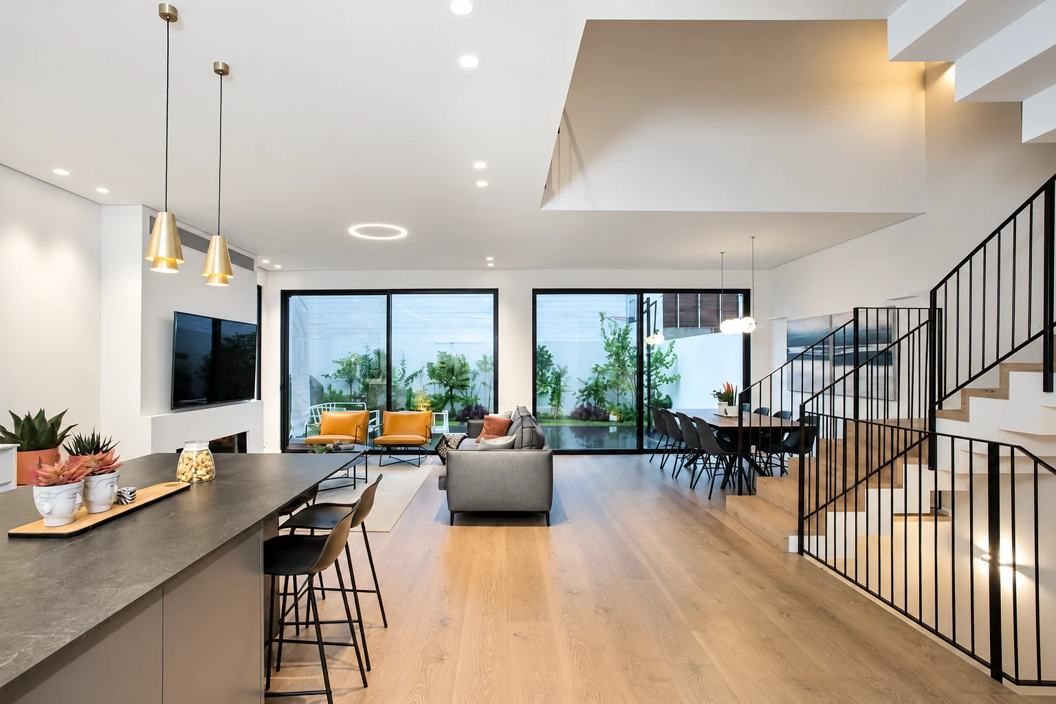 Open-plan kitchen and living room with floor-to-ceiling windows