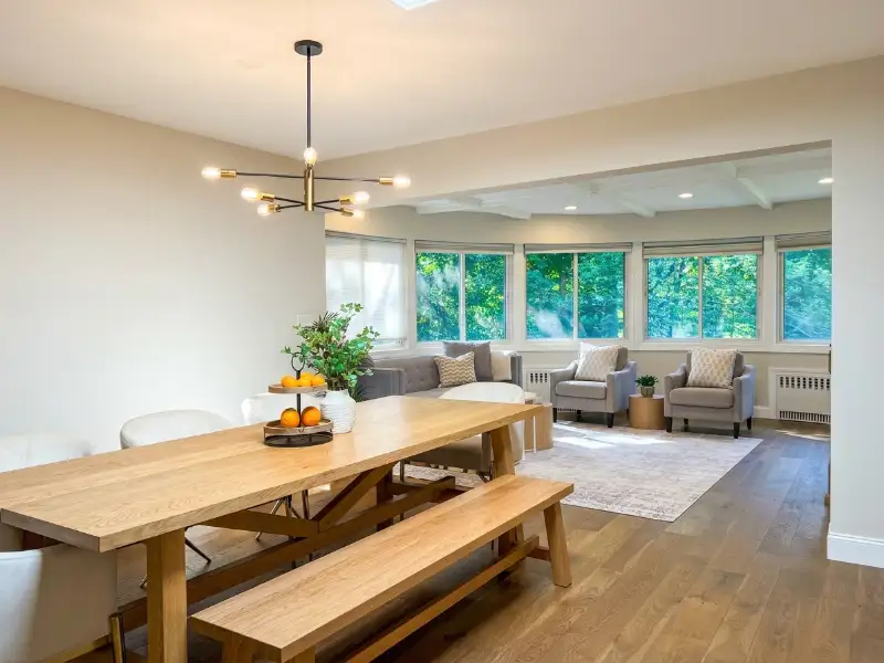 Dining room with a long table and bench beside the windows