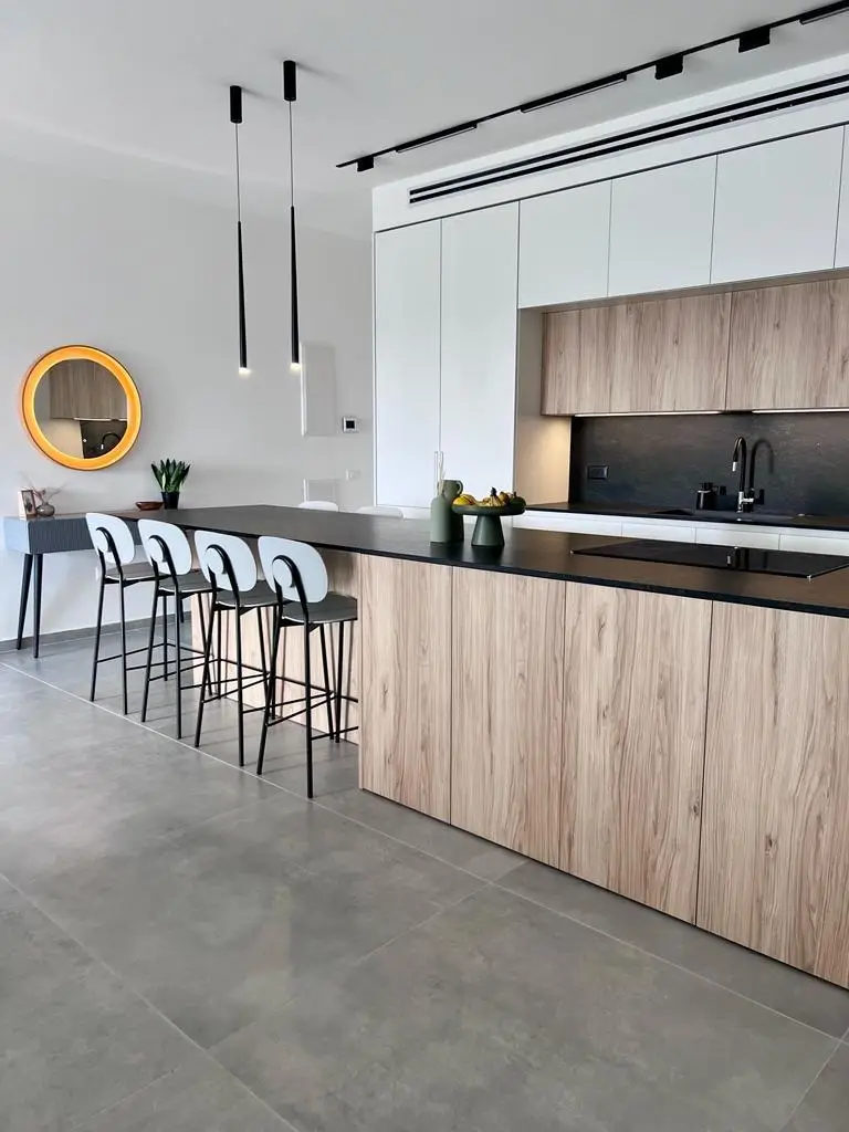 Warm wood kitchen with black pendant lighting