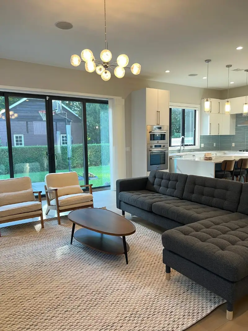 Open living and dining room with a charcoal sectional