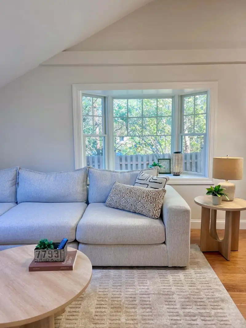 Bay window seating with a pale blue sofa